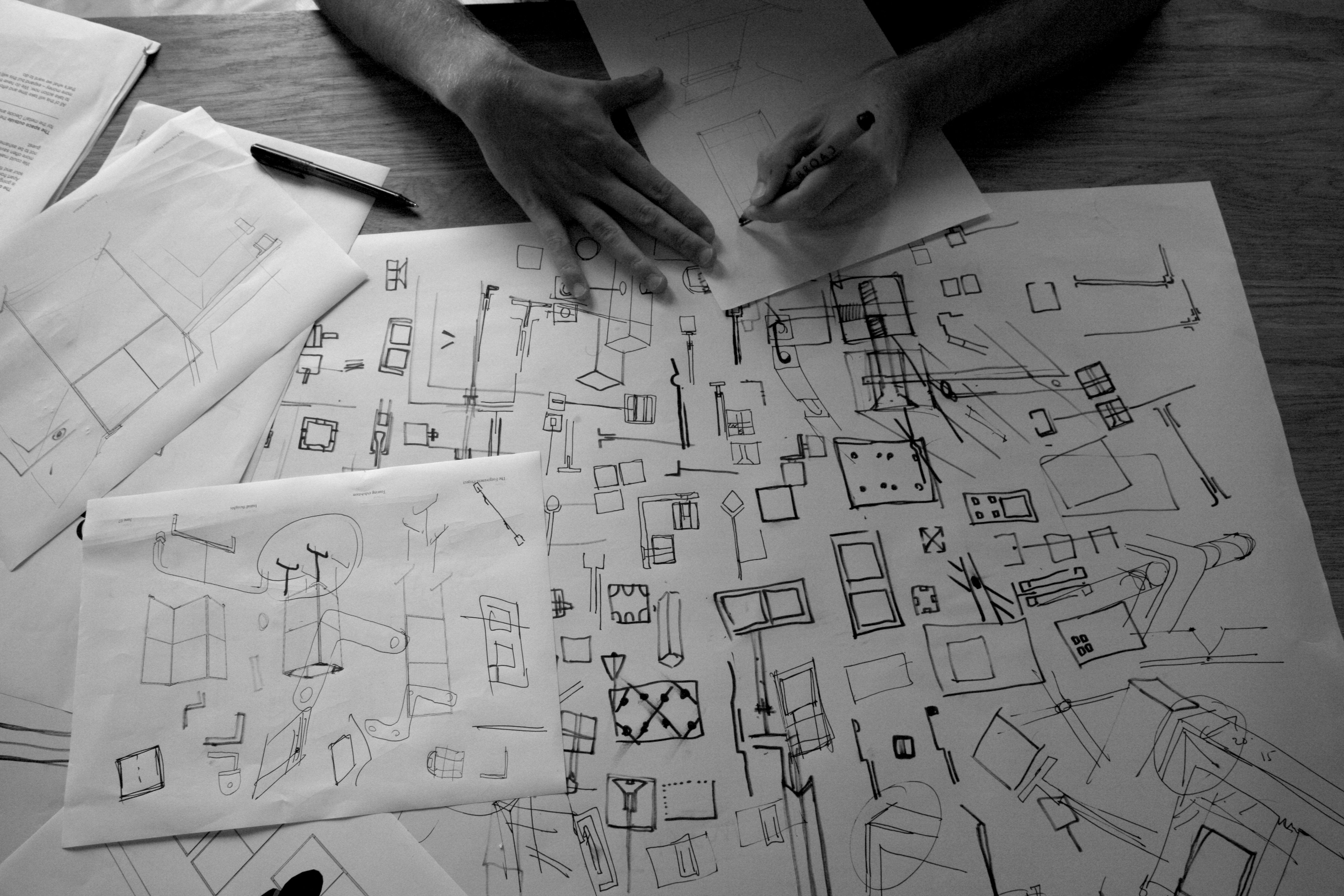 standard8 designer sketching designs on paper