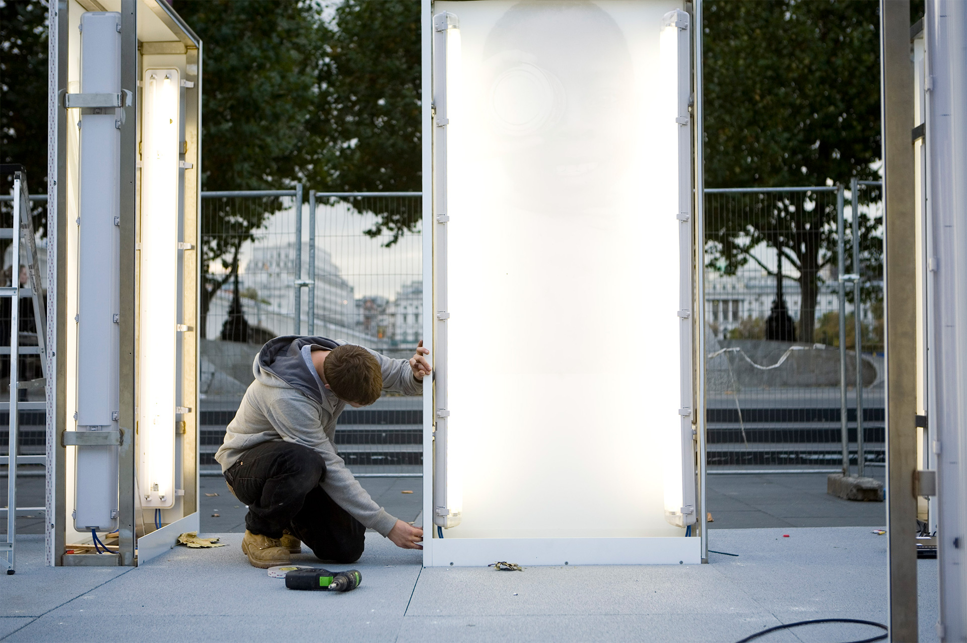 Standard8 team member installing a photo display light box at National Theatre London 